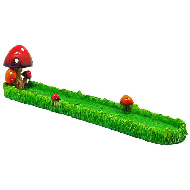 Mushrooms growing in grass incense burner holder